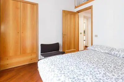 a bedroom with a bed and a chair in it at Casa Vacanze Risorgimento in Rome