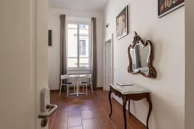 a room with a mirror and a table and a mirror at Appartamento Via Genova in Rome