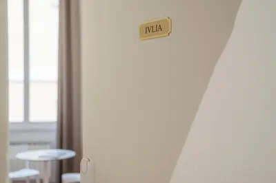 a door with a risk sign on it next to a table at Appartamento Via Genova in Rome