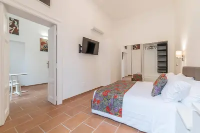 a bedroom with a bed and a tv in it at Appartamento Via Genova in Rome
