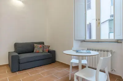 a living room with a couch and a table at Appartamento Via Genova in Rome