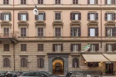 a large building with cars parked in front of it at Appartamento Via Genova in Rome