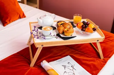 a tray of breakfast foods on a table on a bed at Town House Campo De Fiori in Rome