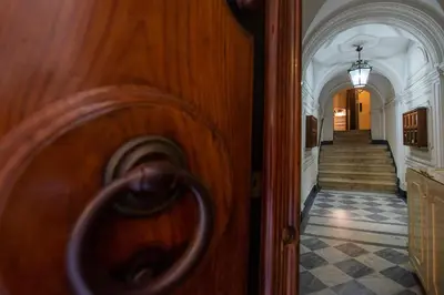 a view of a hallway with a door and a staircase at Town House Campo De Fiori in Rome