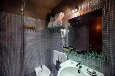 a bathroom with a sink and a mirror at Town House Campo De Fiori in Rome