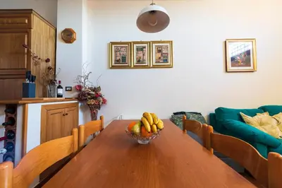 a dining room table with a bowl of fruit on it at Toberto Apartment in Rome