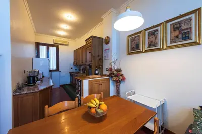 a kitchen and a table with a bowl of fruit on it at Toberto Apartment in Rome