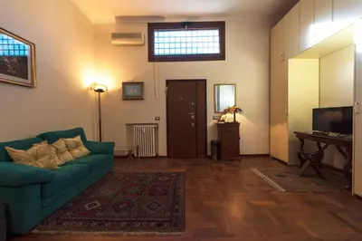 a living room with a green couch and a television at Toberto Apartment in Rome