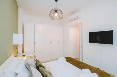 a bedroom with a bed and a flat screen tv at Ottoboni Apartment, 4 persone, balcone, Wi-Fi, Stazione Tiburtina in Rome