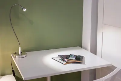 a white table with a lamp and a book on it at Ottoboni Apartment, 4 persone, balcone, Wi-Fi, Stazione Tiburtina in Rome