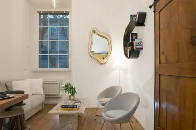 a living room with a couch and a mirror at Marvellous apt near Vatican in Rome