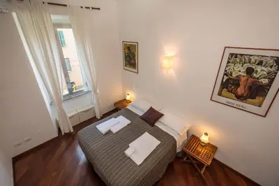 a small bedroom with a bed and a window at Annalisa Apartment in Rome