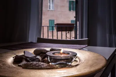 a candle sitting on top of a table with shells at Annalisa Apartment in Rome