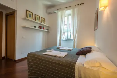 a bedroom with a bed with two towels on it at Annalisa Apartment in Rome
