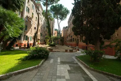 an empty street in a city with trees and buildings at Annalisa Apartment in Rome