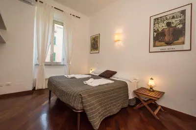 a bedroom with a bed and a table and a window at Annalisa Apartment in Rome