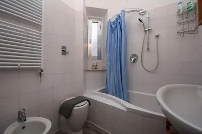 a bathroom with a toilet and a tub and a sink at Annalisa Apartment in Rome