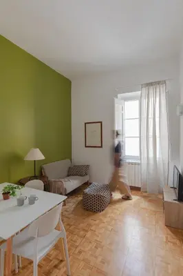 a person is walking through a living room at Giglio quiet apartment at Campo dei Fiori in Rome