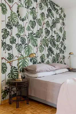 a bedroom with a bed with a green leafy wallpaper at Giglio quiet apartment at Campo dei Fiori in Rome