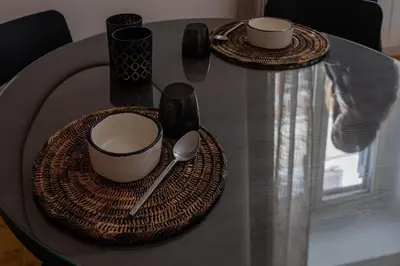 a table with two plates and cups and a spoon at Giglio quiet apartment at Campo dei Fiori in Rome