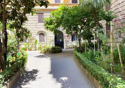 a bedroom with a bed and a lamp and curtains at Sweet Dream Roma Termini in Rome