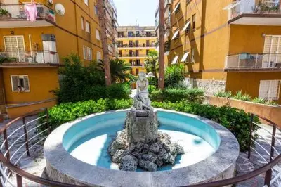 a fountain in the middle of a building at Romantic & Comfy Apartment Monteverde in Rome