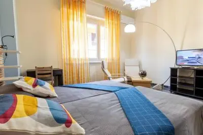 a bedroom with a large bed and a television at Romantic & Comfy Apartment Monteverde in Rome