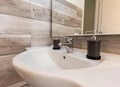 a bathroom with a white sink and a mirror at Romantic & Comfy Apartment Monteverde in Rome