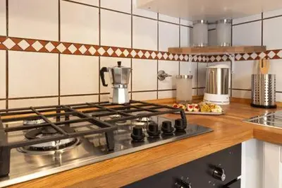 a kitchen with a stove top in a kitchen at Romantic & Comfy Apartment Monteverde in Rome