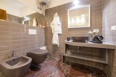 a bathroom with a sink and a toilet and a mirror at Lombardia40 Luxury Suites in Rome