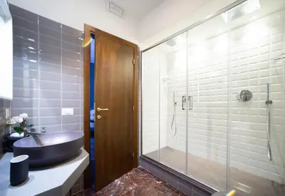 a bathroom with a sink and a glass shower at Lombardia40 Luxury Suites in Rome