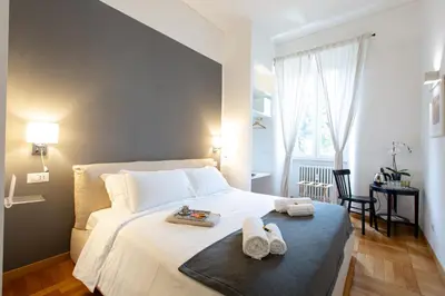 a bedroom with a bed with towels on it at Lombardia40 Luxury Suites in Rome