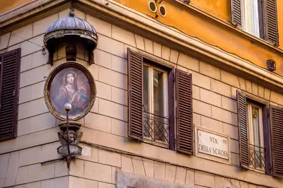 a clock on the side of a building with windows at Navona Blue Apartment in Rome
