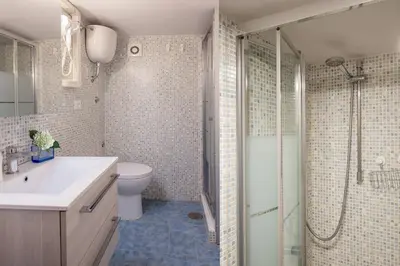 a bathroom with a shower and a sink and a toilet at Navona Blue Apartment in Rome