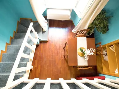 a staircase in a house with blue walls and wooden floors at Navona Blue Apartment in Rome