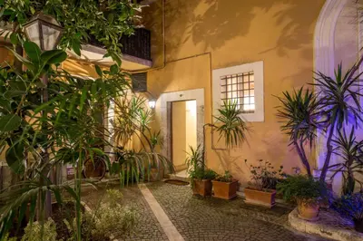 a courtyard with potted plants in a building at Navona White Apartment in Rome