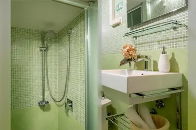 a bathroom with a sink and a shower at Navona White Apartment in Rome