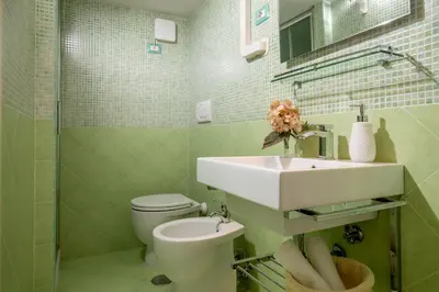 a bathroom with a white sink and a toilet at Navona White Apartment in Rome