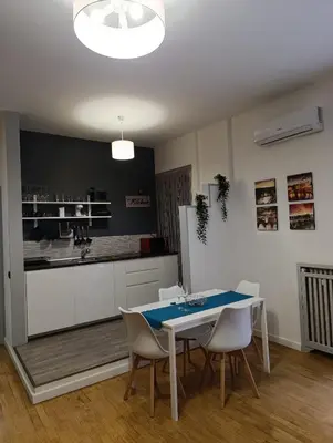 a dining room with a table and chairs and a kitchen at Oasi Del Vaticano in Rome