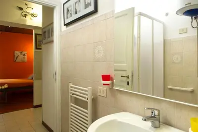 a bathroom with a sink and a mirror at GREGORIANA HOUSE - Appartamento con Vista su Roma in Rome