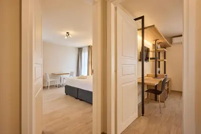 a bedroom with a bed and a desk and a table at Relais Tiburtina in Rome