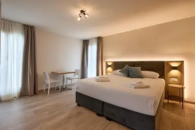 a bedroom with a large bed and a table at Relais Tiburtina in Rome