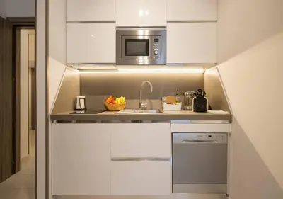 a small kitchen with a sink and a microwave at Casette Romane 