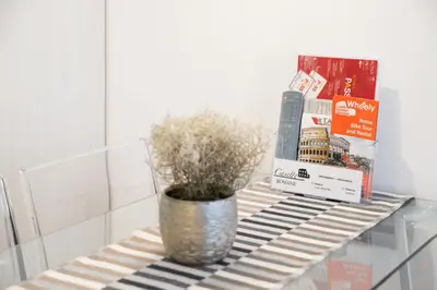 a table with a potted plant and books on it at Casette Romane 