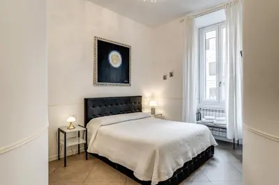 a bedroom with a bed and a picture on the wall at Bless&B G.H. in Rome