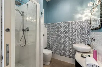 a bathroom with a shower and a toilet and a sink at Bless&B G.H. in Rome