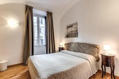 a bedroom with a bed and a large window at Bless&B G.H. in Rome