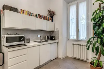 a white kitchen with a microwave and a sink at Bless&B G.H. in Rome