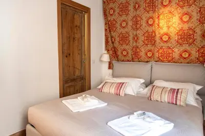 a bed with two towels sitting on top of it at Monti Bespoke in Rome