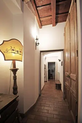 a hallway with a lamp and a hallway leading into a room at Monti Bespoke in Rome